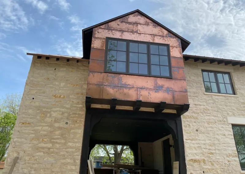 Copper metal panel facade on a stone building for Metal Roof Coating in Gonzales